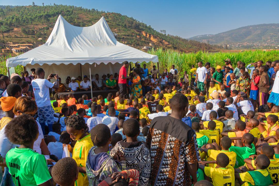 Visitors meeting players and coaches on the pitch